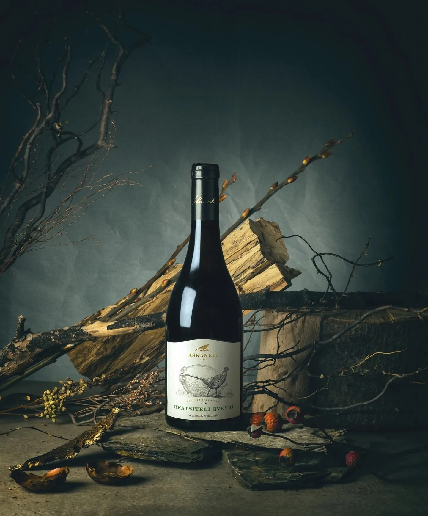 A wine bottle amid wood and herbs — BrandBar's taste culture atmosphere